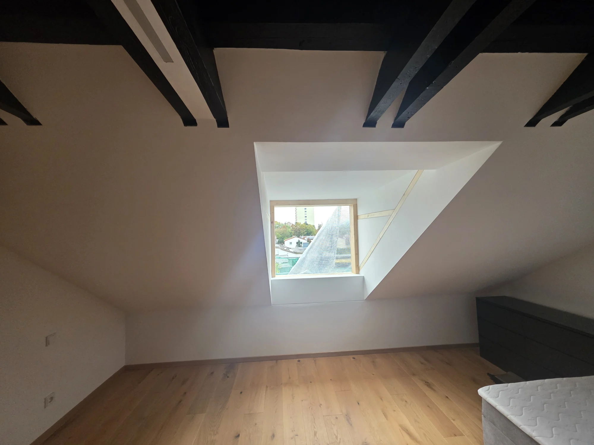 Saniertes Dachgeschoss mit Holzboden und Dachfenster – Mesret Bau